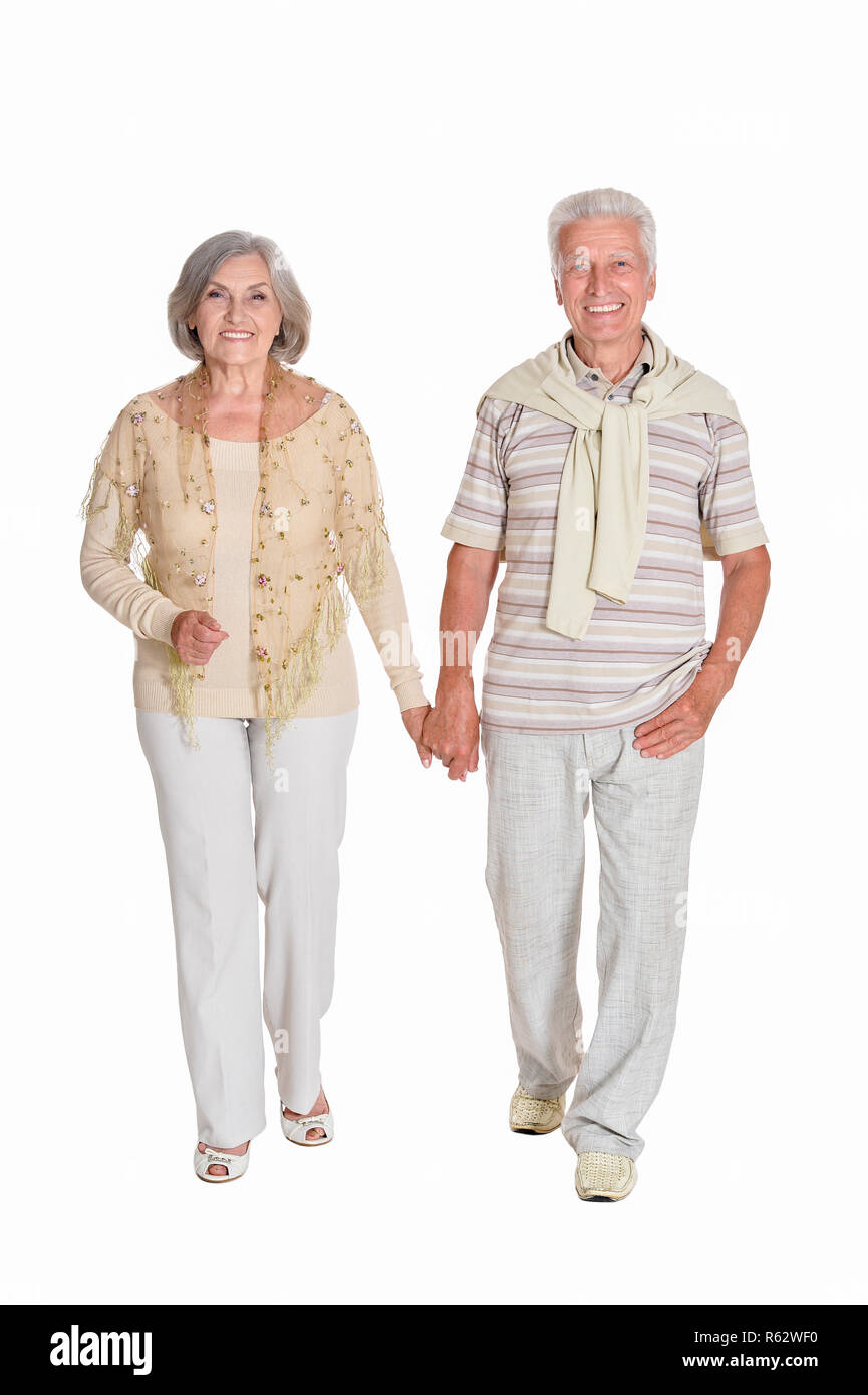 Portrait of senior couple holding hands on white background Banque D'Images