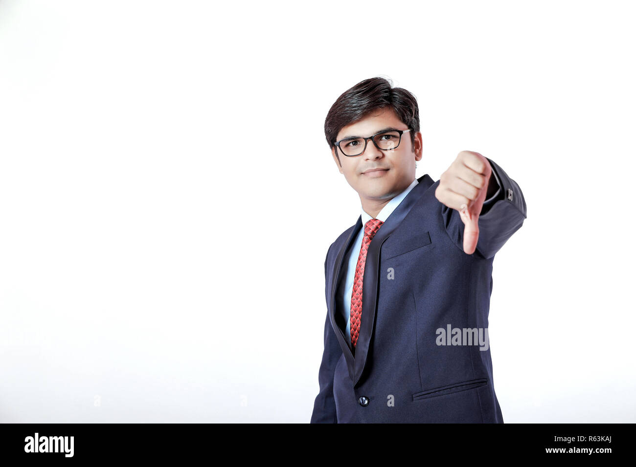 Young Indian businessman showing thumb down Banque D'Images