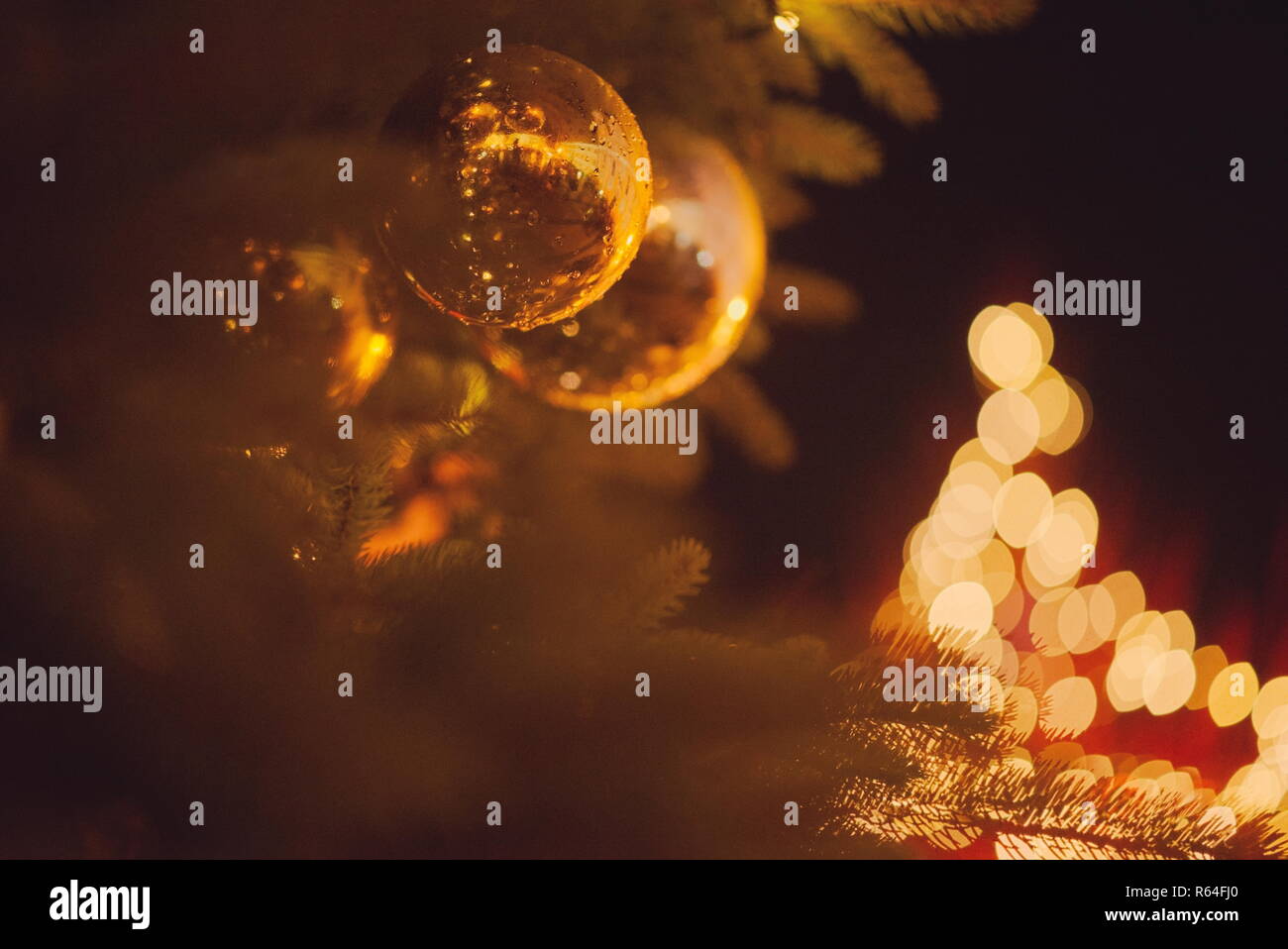 Gros plan de l'arbre de Noël avec Golden Orbs et Lumières floues Banque D'Images