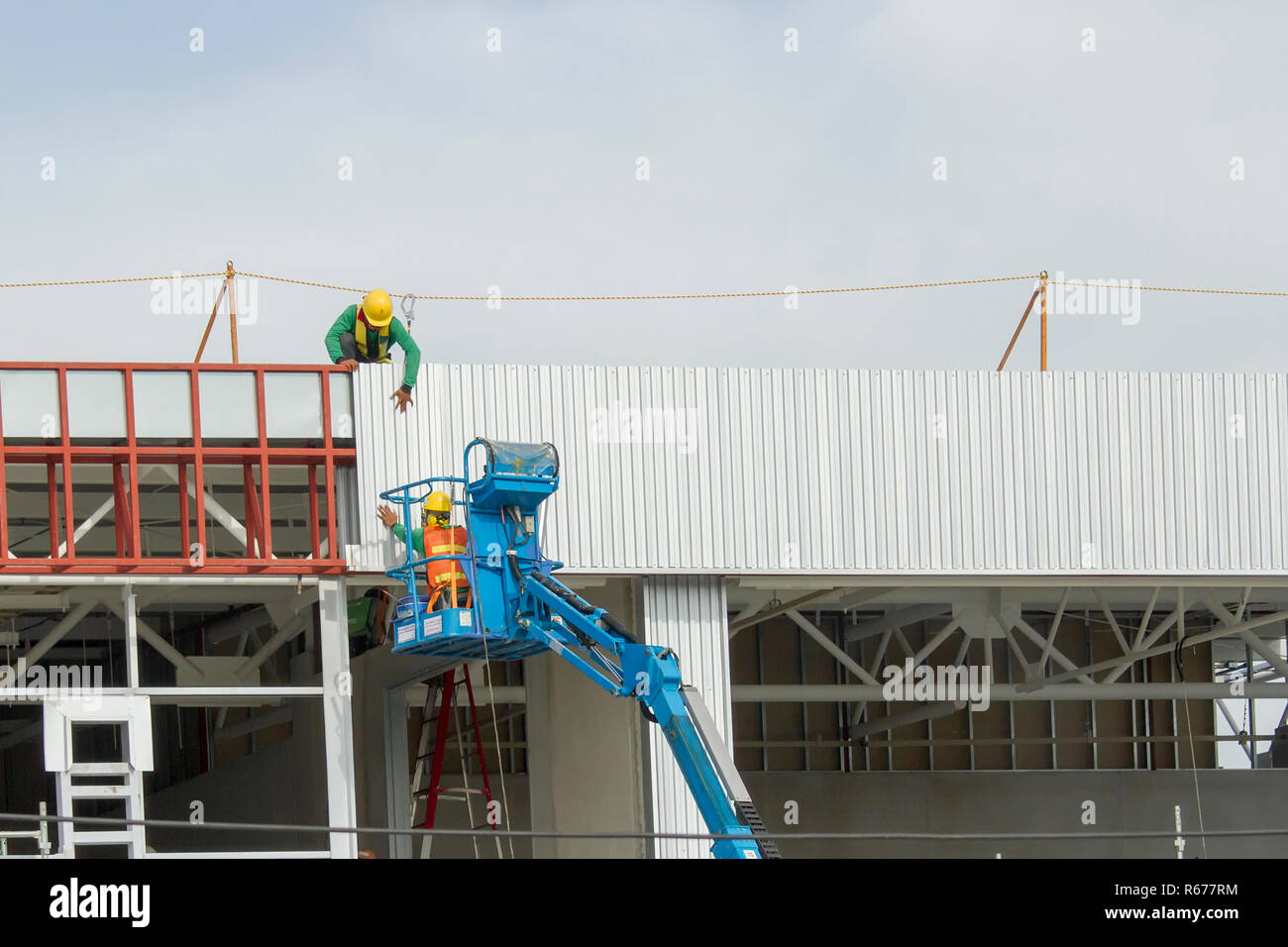 Les paniers sont les travailleurs d'une installation de feuille, la construction d'une usine. Banque D'Images