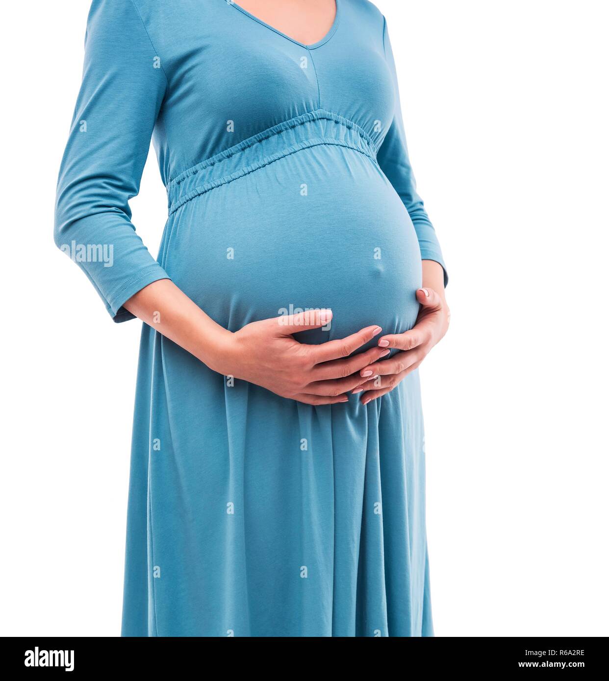 Femme enceinte tenir la main sur le ventre. Close-up. Banque D'Images