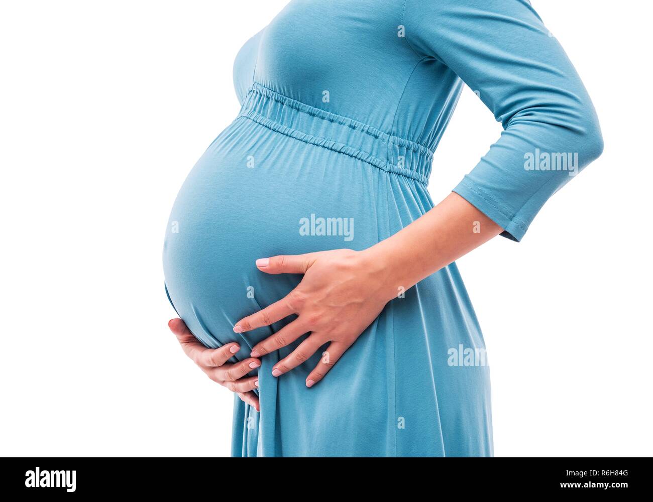 Femme enceinte tenir la main sur le ventre. Close-up. Banque D'Images