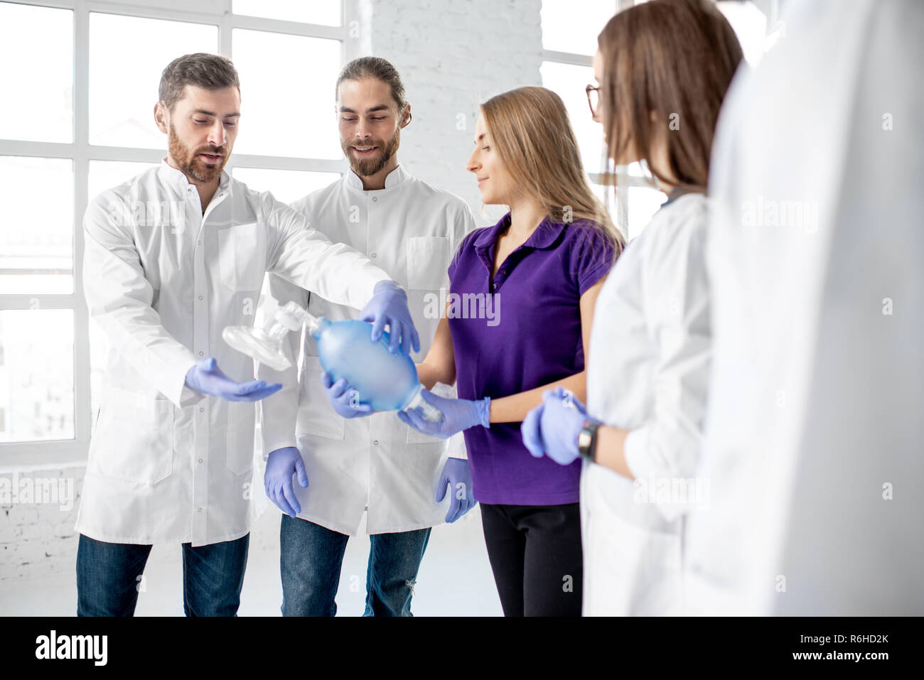 Groupe de medecins se tenant ensemble avec la respiration outil au cours de la formation aux premiers secours à l'intérieur Banque D'Images