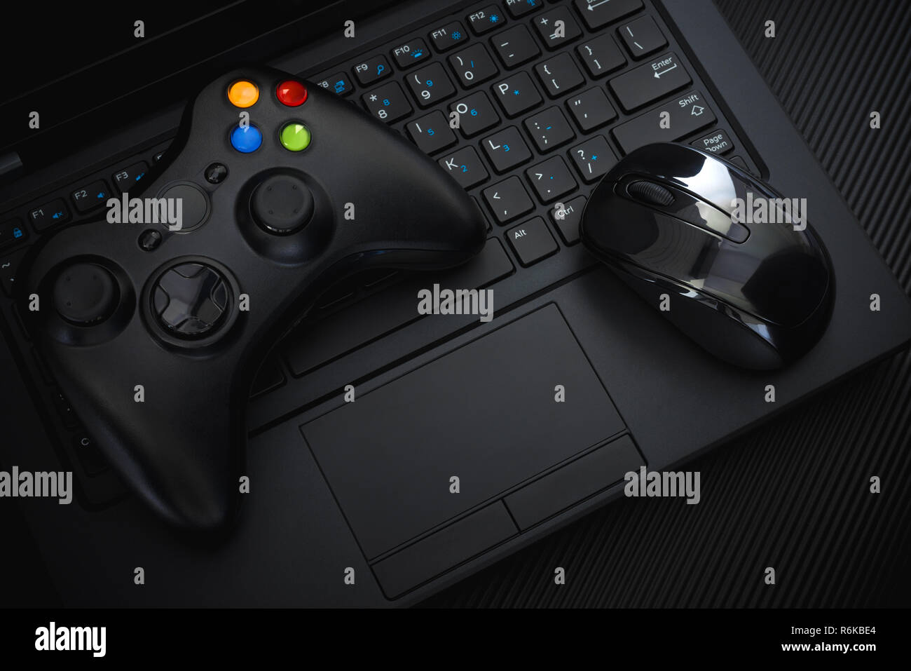 Manette de jeu et souris sur un clavier de PC sur fond noir ; manettes de  jeux vidéo ; Joystick vs clavier ; l'arrière-plan Vue de dessus Photo Stock  - Alamy
