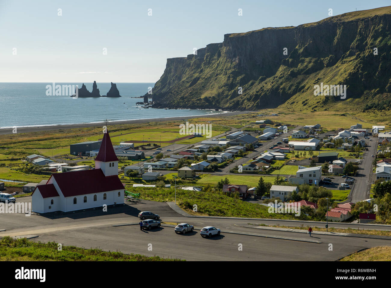 La ville islandaise de Vik dans le sud de l'Islande sur une journée ensoleillée face à la mer avec les colonnes de roche de Reynisdrangar Banque D'Images