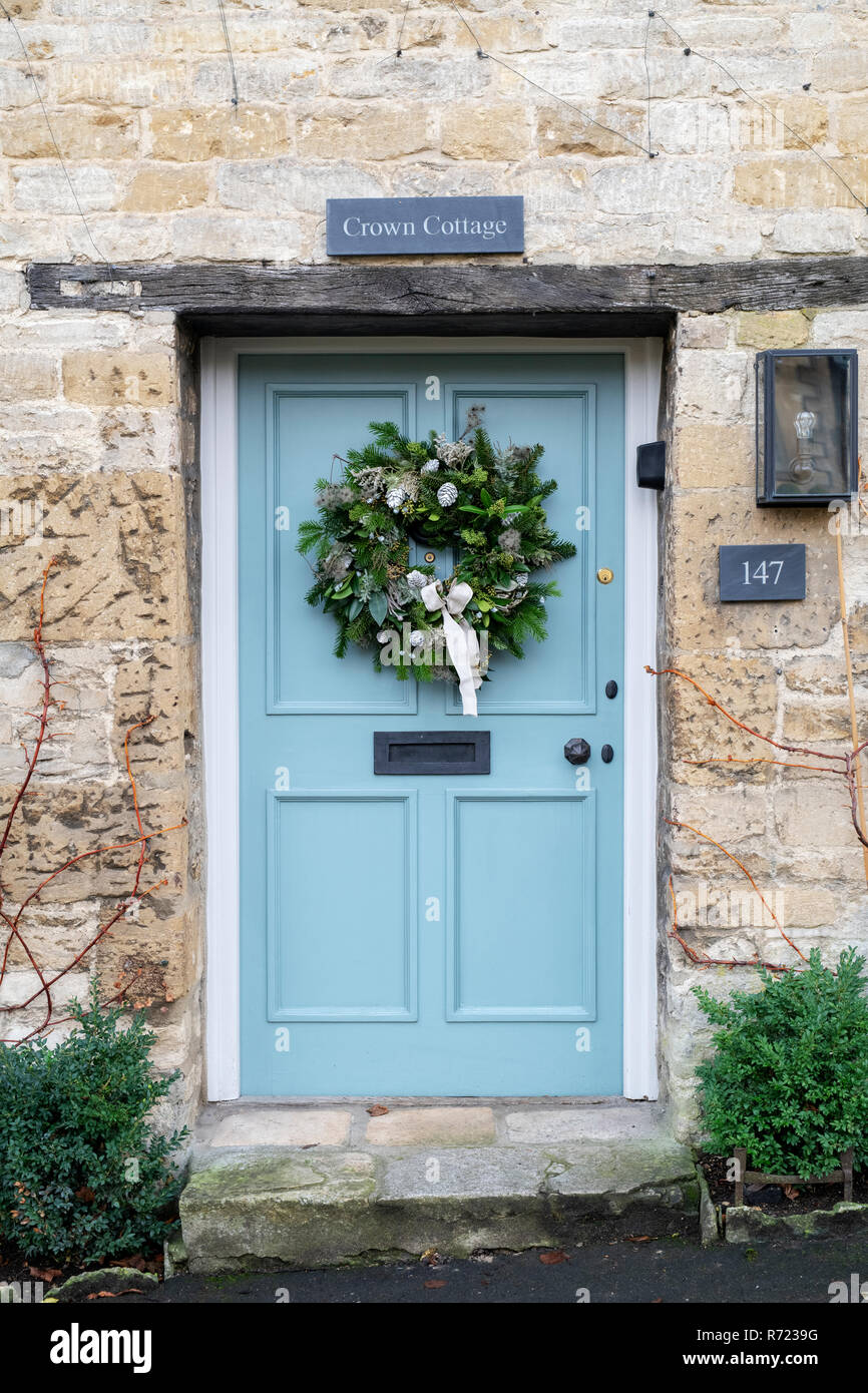 Couronne de Noël sur une porte du chalet à Burford. Cotswolds, Oxfordshire, Angleterre Banque D'Images