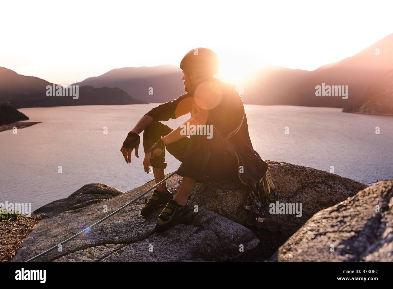 Rock climber appréciant le coucher du soleil le Malamute, Squamish, Canada Banque D'Images