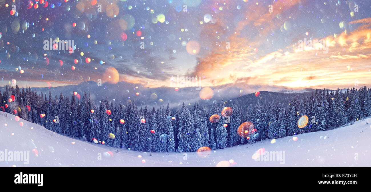 Orange fantastique paysage d'hiver dans les montagnes de neige par la lumière du soleil rougeoyant. Scène hivernale spectaculaire avec des arbres enneigés. Lumière effet bokeh DOF post-traitement. Vacances de Noël collage Banque D'Images