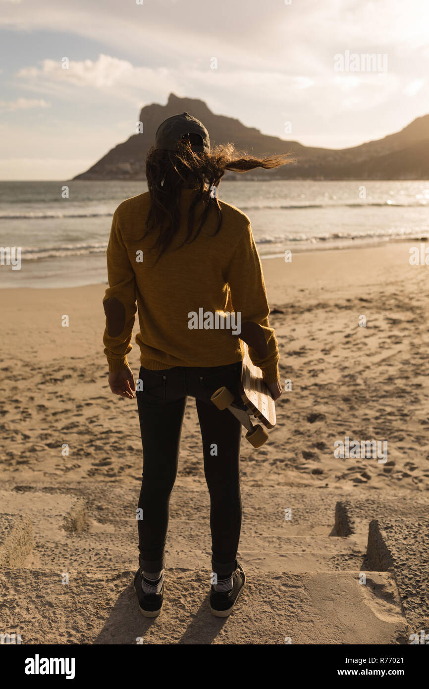 Femme debout avec roulettes sur beach Banque D'Images