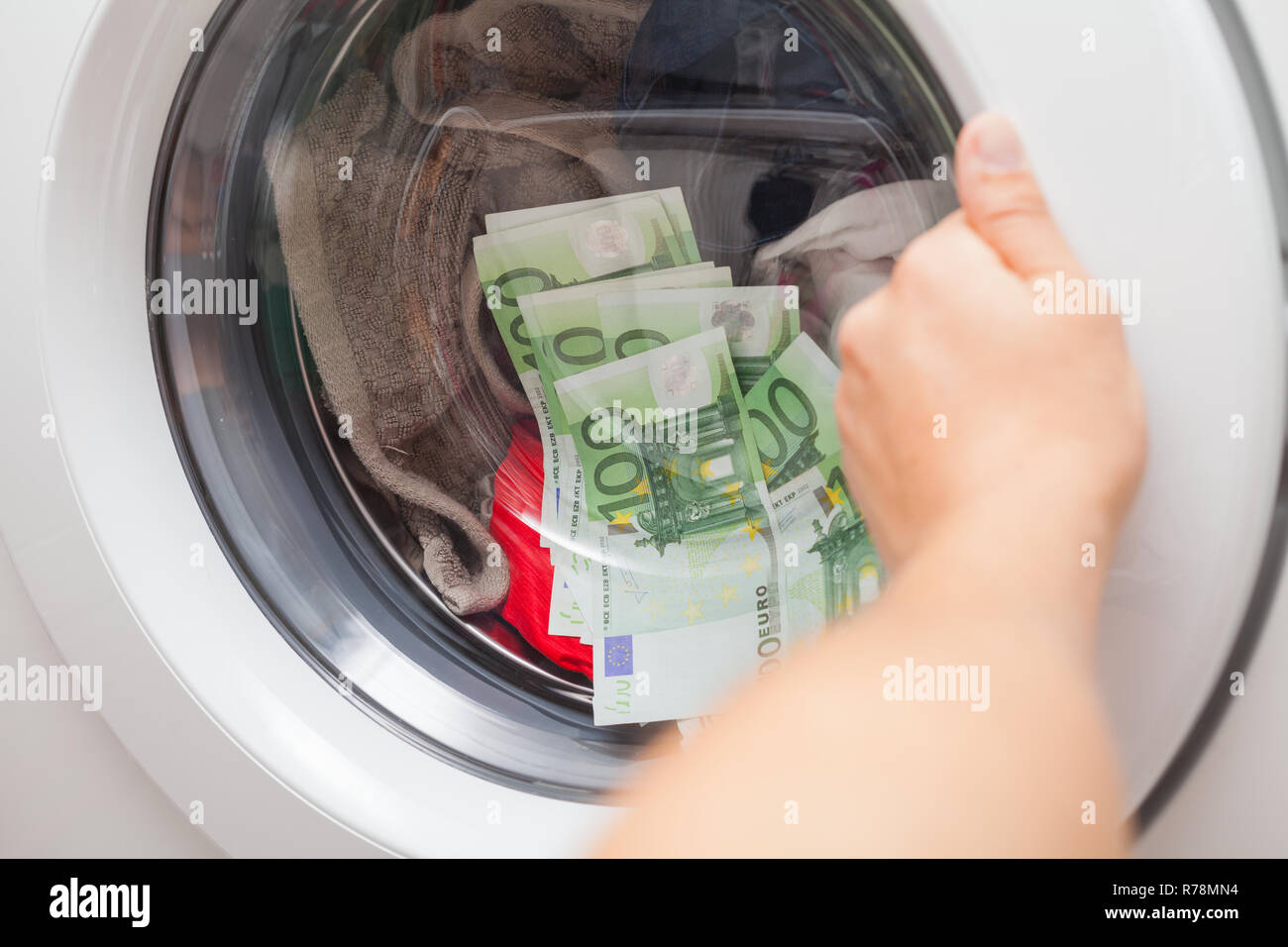 Beaucoup d'argent bloqué dans la machine à laver, l'homme essayant d'ouvrir  la porte Photo Stock - Alamy