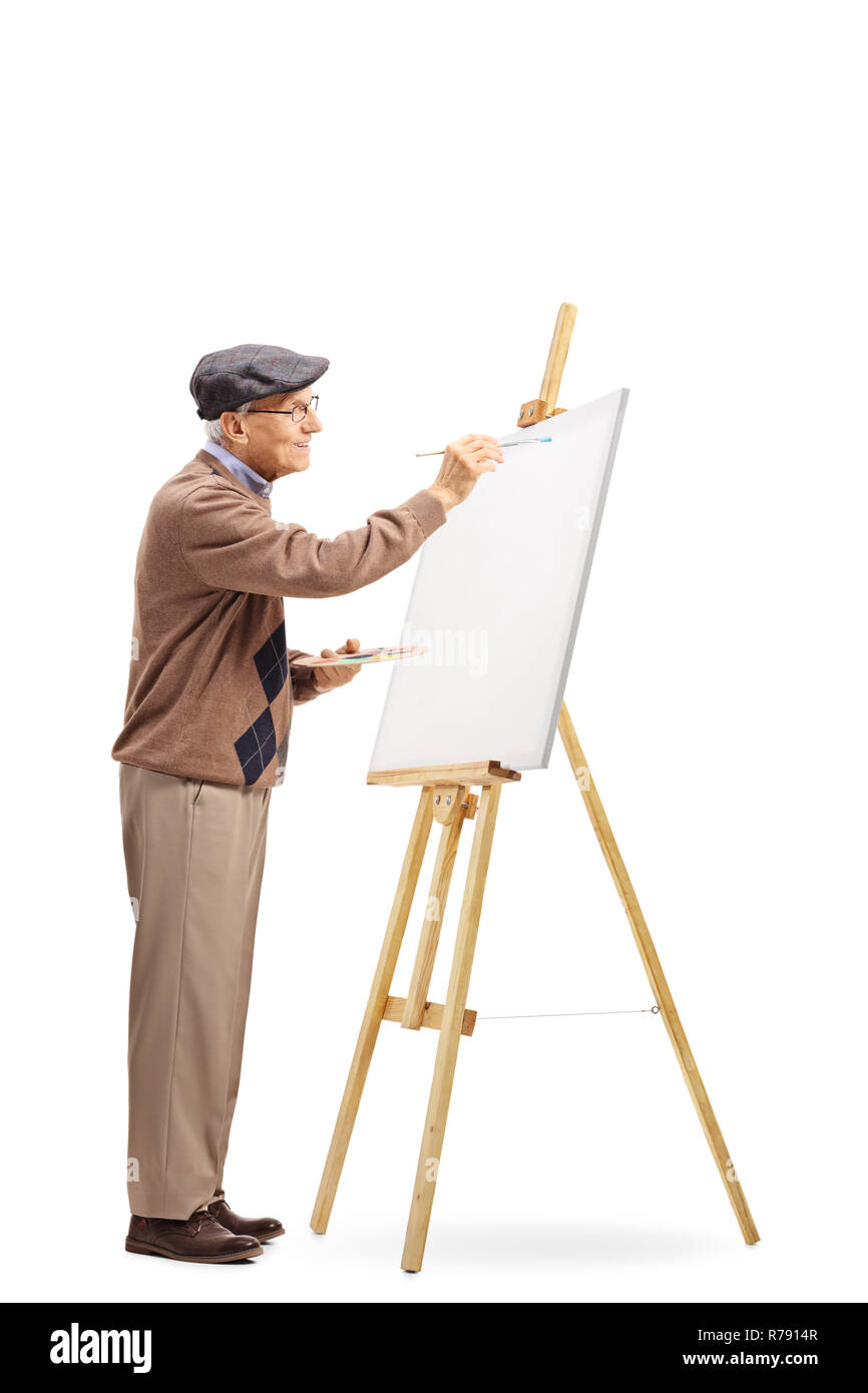Longueur totale d'un artiste masculin senior de peindre sur une toile isolé sur fond blanc Banque D'Images