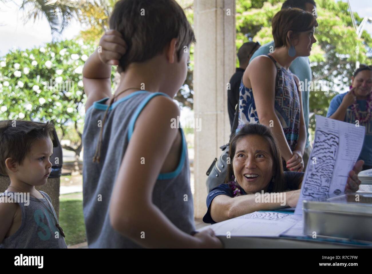 PEARL HARBOR (17 mai 2017) Diane Tom-Ogata, membre de la société et de l'éducation Voyage polynésien-membre de l'équipage du navire Polynésien Hokule'a (centre), enseigne aux enfants à propos de l'Hokule'a, dans le monde entier voyage tour à un affichage interactif axé sur la famille au cours d'une des îles du Pacifique Asiatique-américain (AAPI) célébration du Mois du patrimoine tenue à l'événement commémoratif Hickam Theatre sur Joint Base Harbor-Hickam Pearl. Le thème de cette année, la célébration de AAPIHM est "s'unir nos voix en parlant ensemble." L'événement a été l'occasion pour reconnaître et célébrer la riche diversité, leadership Banque D'Images