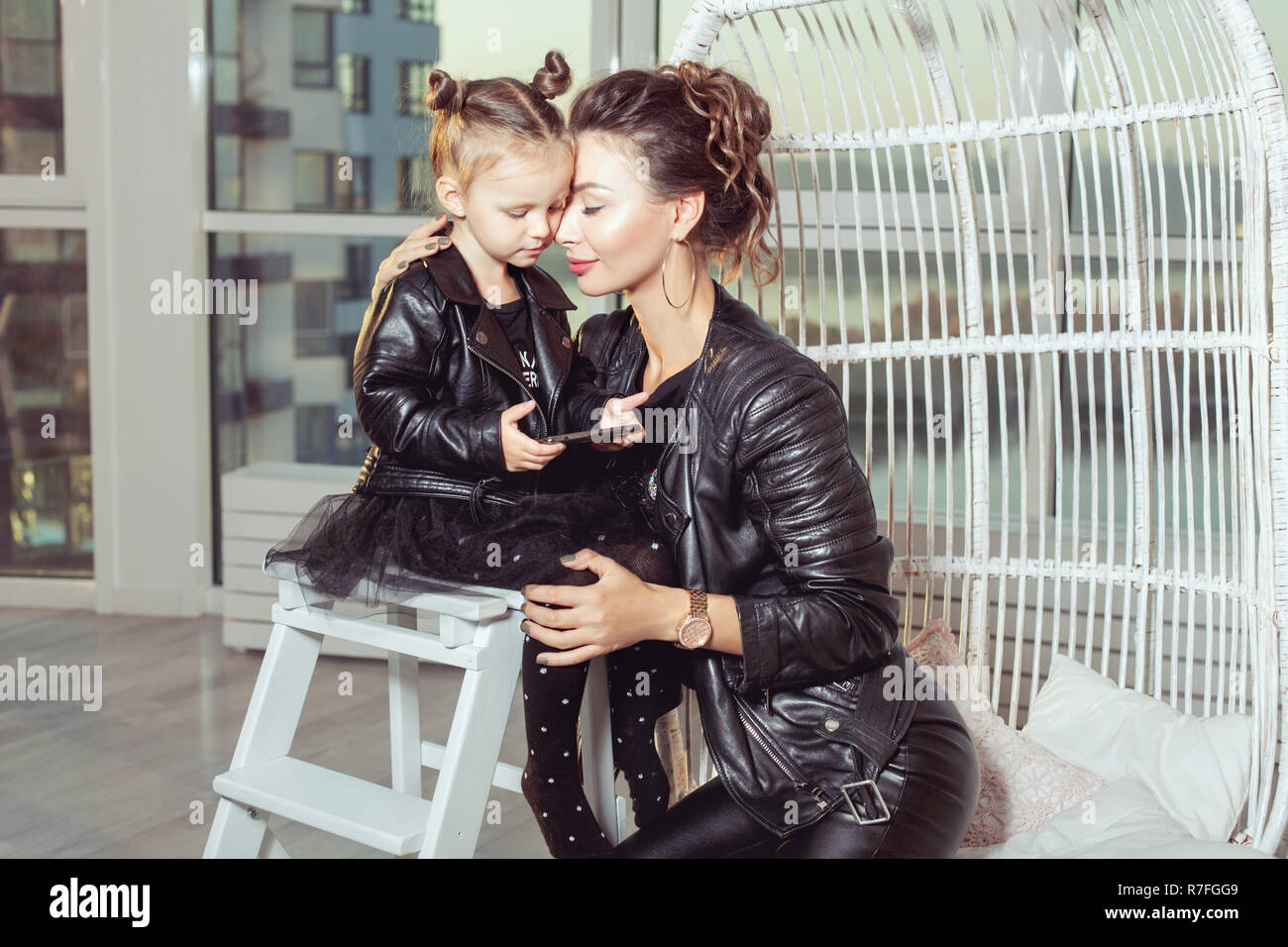 Portrait d'une jeune maman et sa fille en blousons de cuir noir. Banque D'Images