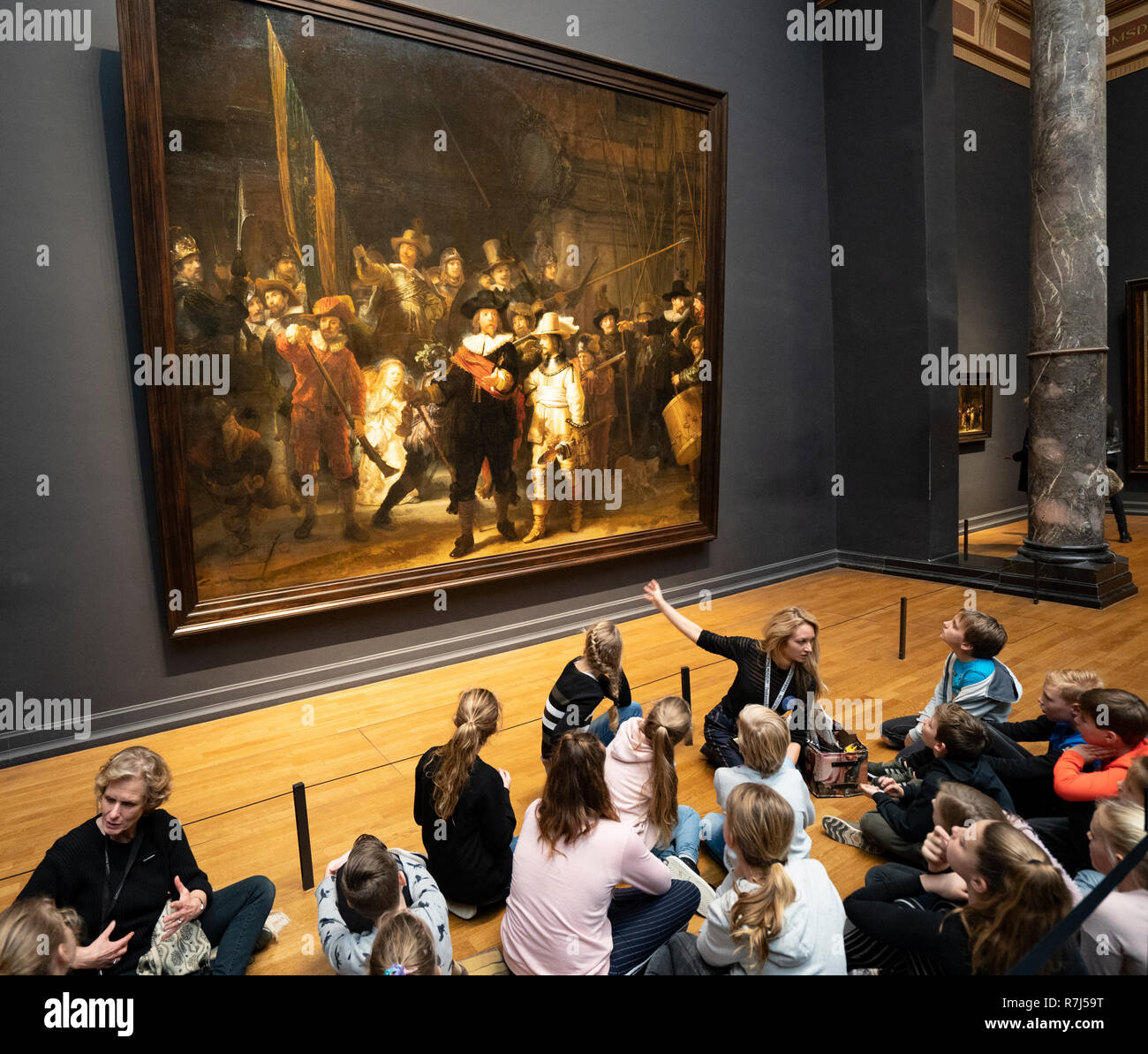 Les visiteurs à l'écoliers nuit regarder la peinture de Rembrandt van Rijn au Rijksmuseum à Amsterdam, Pays-Bas Banque D'Images