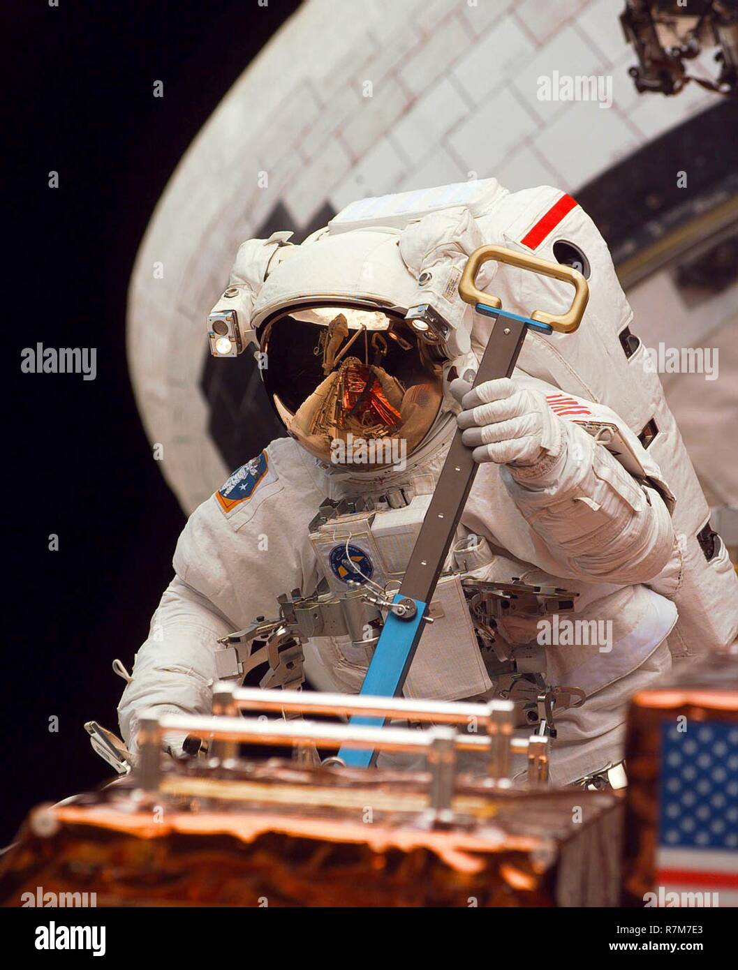 L'astronaute américain Mark C. Lee travaille sur l'entretien et la mise à niveau du télescope spatial Hubble attaché à la cargaison par de la navette spatiale Discovery le 16 février 1997 dans l'orbite de la Terre. Banque D'Images