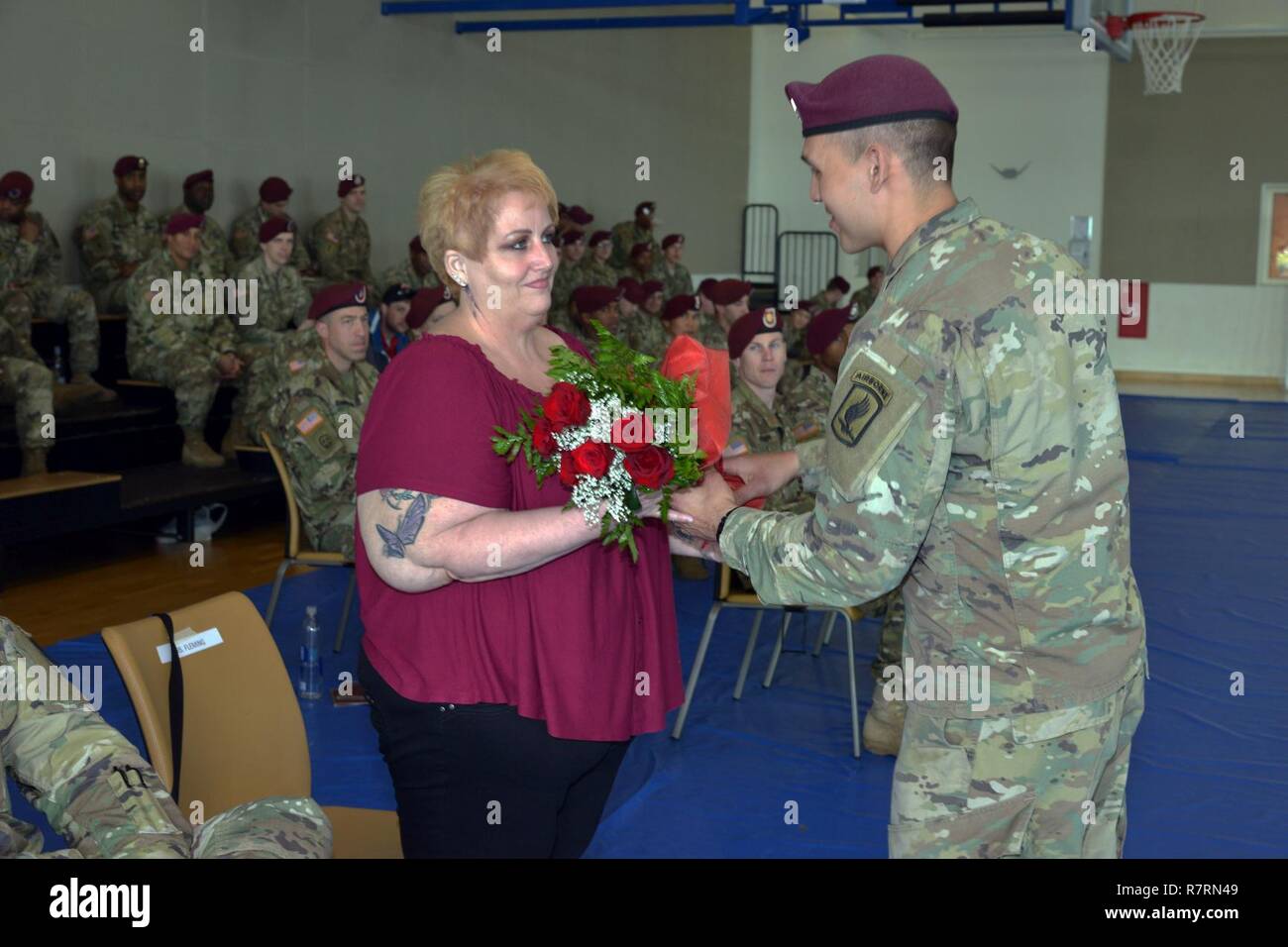 Femme de 1er sortant Le Sgt. William L. Fleming, reçoit un bouquet de roses rouges à partir de parachutiste au cours de la cérémonie de changement de responsabilité pour l'entreprise C, 54e bataillon du génie de la Brigade, 173e Brigade aéroportée, Avril 5, 2017 à Caserma Del Din à Vicenza, Italie. La 173e Brigade aéroportée basée à Vicenza, Italie, est la force de réaction d'urgence de l'armée en Europe, et il est capable de projeter des forces canadiennes de mener toute la gamme des opérations militaires de l'ensemble de l'Europe centrale et de l'État, les commandes de l'Afrique domaines de responsabilité. Banque D'Images