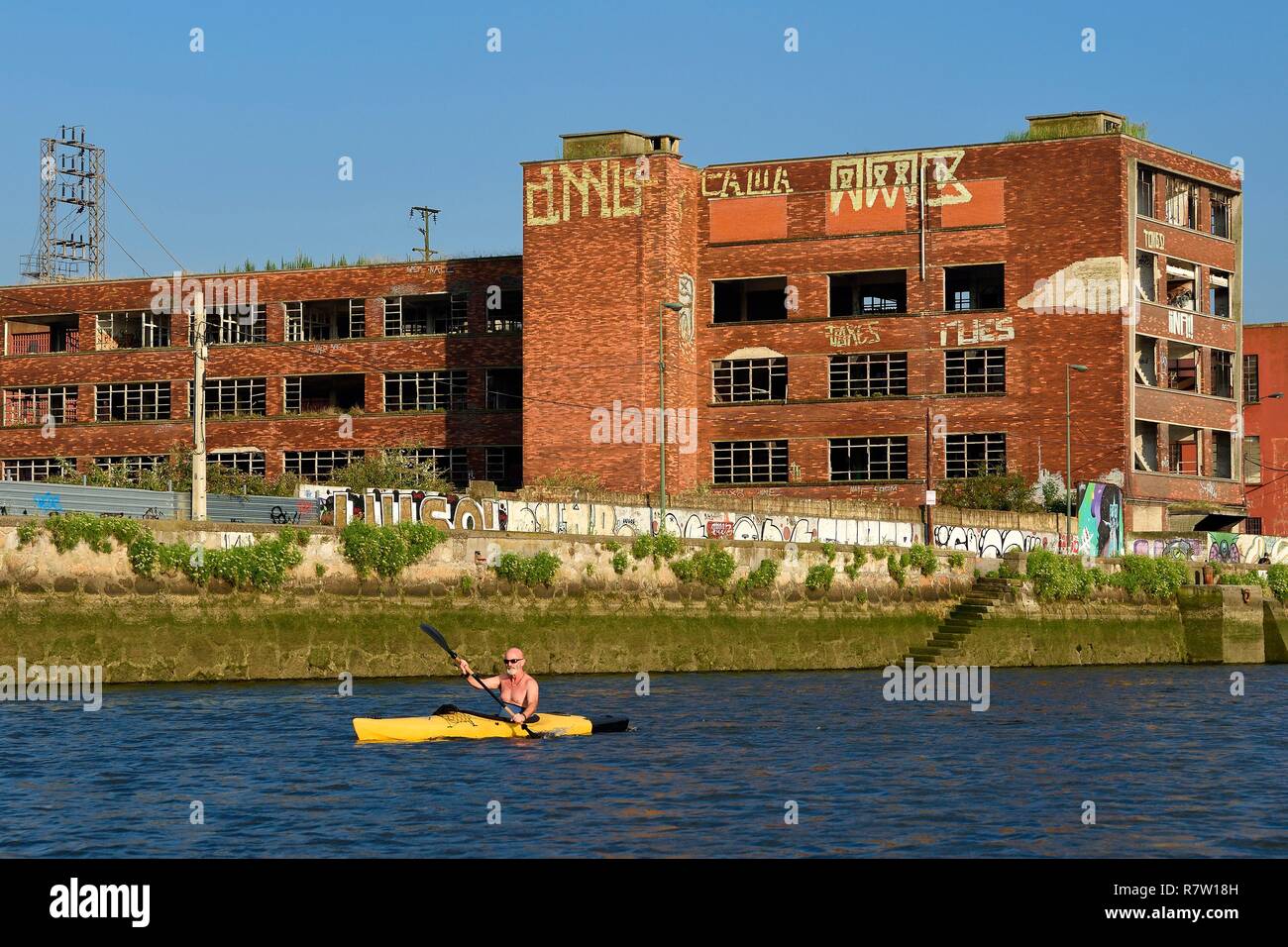 Espagne, Pays Basque, Province de Biscaye, Bilbao, kayakiste allant jusqu'à la rivière Nervión vers la bouche, les friches industrielles de Deusto, ancien bâtiment industriel Banque D'Images