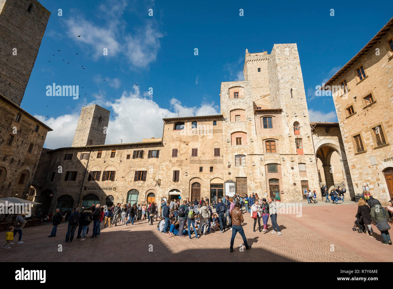 Vue horizontale de la Piazza della Cisterna montrant plusieurs de ses célèbres tours de San Gimignano, Italie. Banque D'Images