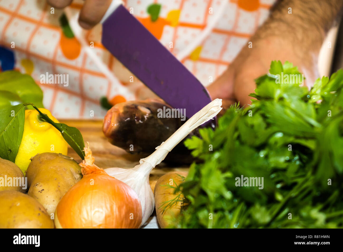 Un homme cuire le dîner, des légumes frais et du poisson dans la cuisine. Mari la préparation d'une surprise pour sa femme le 8 mars, Journée internationale de la femme Banque D'Images