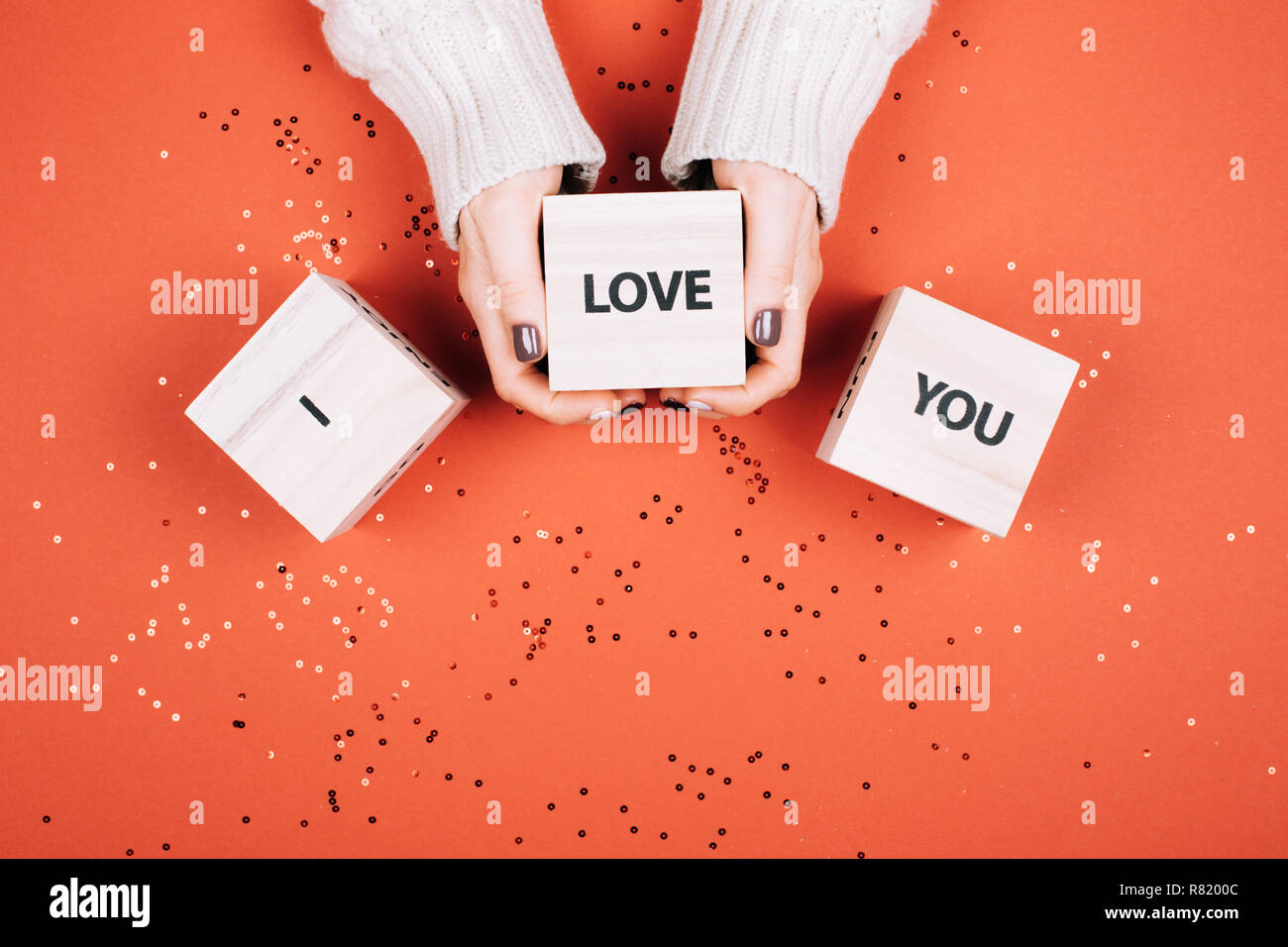 Wonans hands holding glaçons avec du texte je vous aime. Mise à plat de style. Corail vivant - Couleur de l'année 2019. Banque D'Images