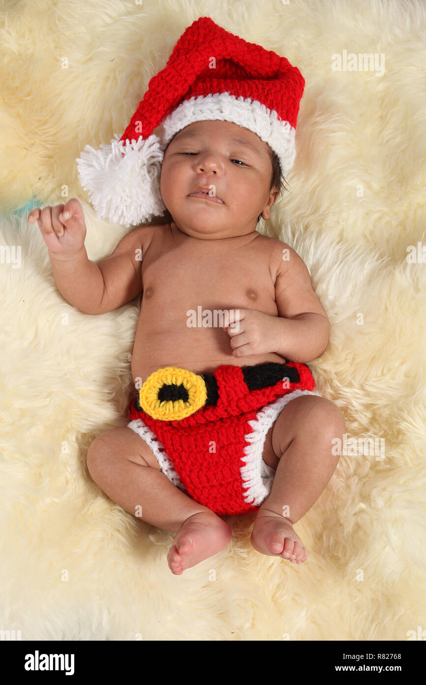 Mixed Race new born baby boy dressed as santa Banque D'Images
