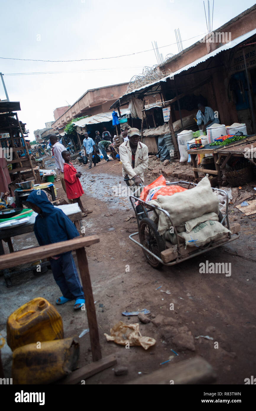 Mali, Afrique - Black man transportant de la nourriture avec un chariot de bois. Marché local de la ville de Bamako Banque D'Images