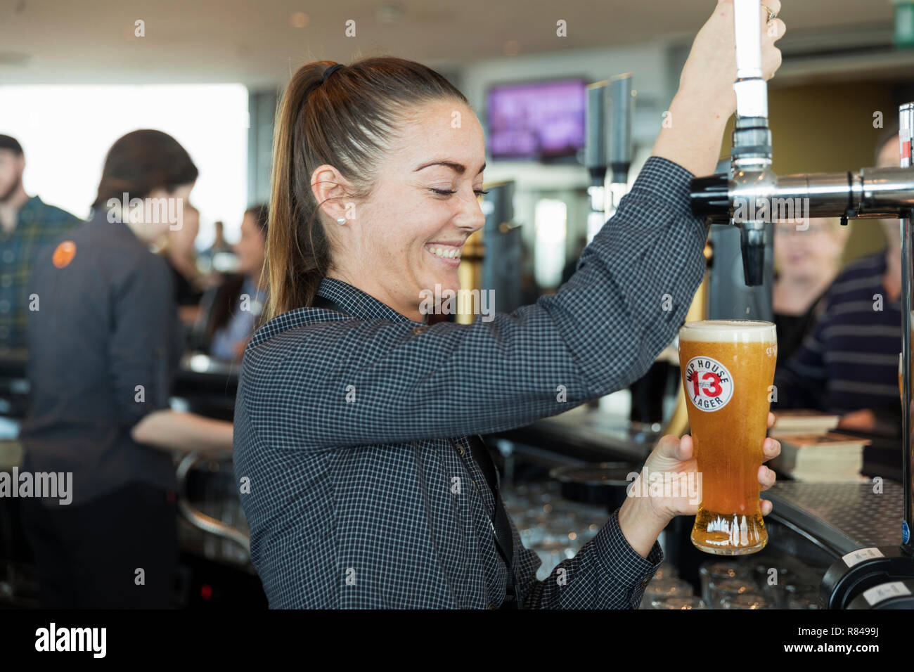 L'Irlande, Dublin, Guinness Storehouse, Gravity Bar, bartender pouring beer. Banque D'Images