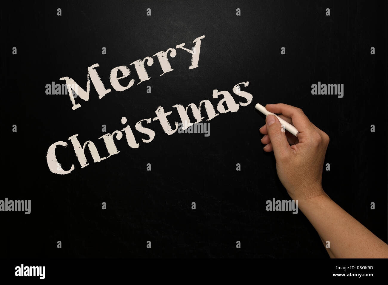 Enseignant écrire Joyeux Noël sur le tableau noir Banque D'Images