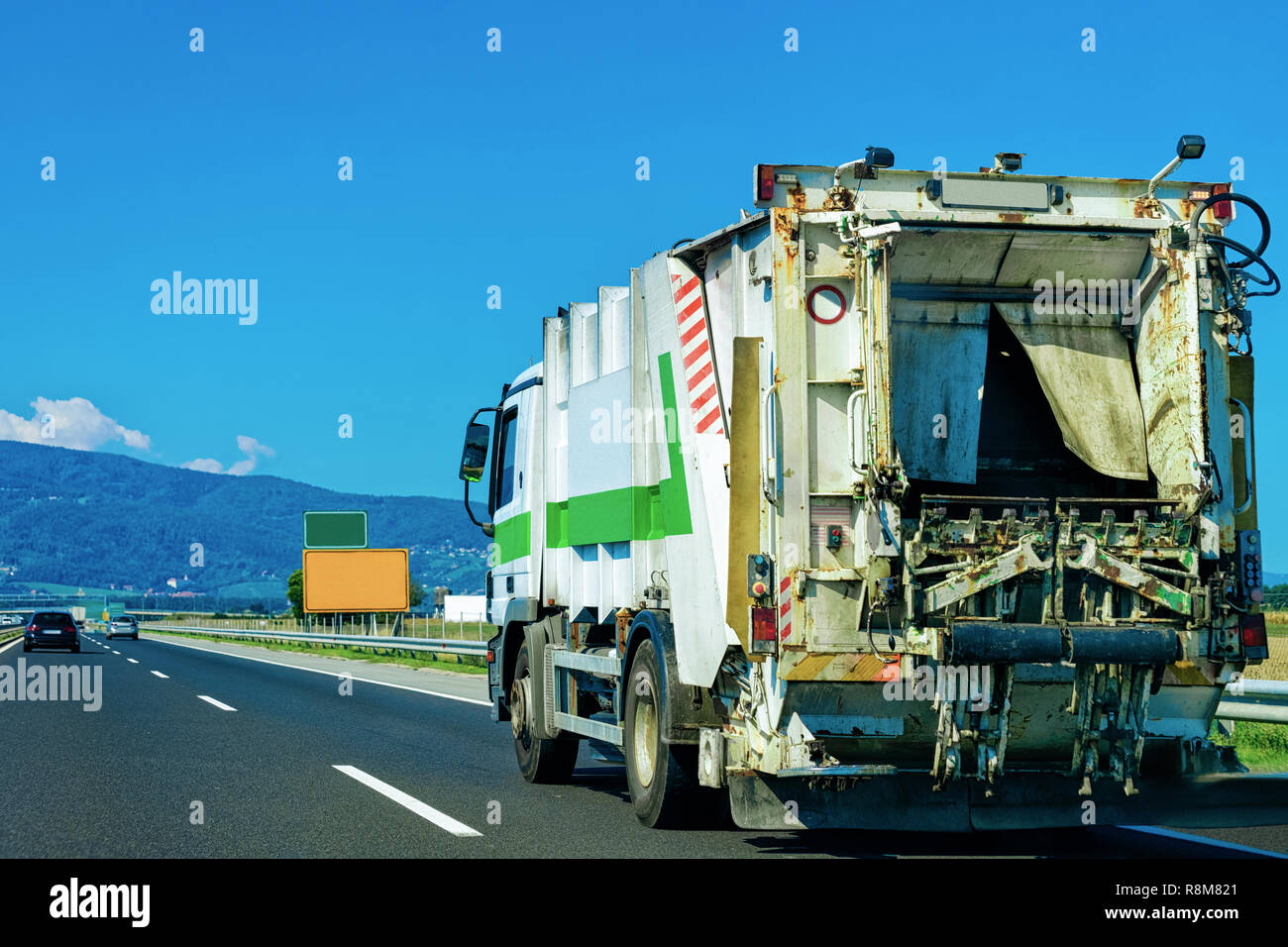 Avec remorque camion transportant des conteneurs à déchets sur la route asphaltée en Slovénie. Banque D'Images