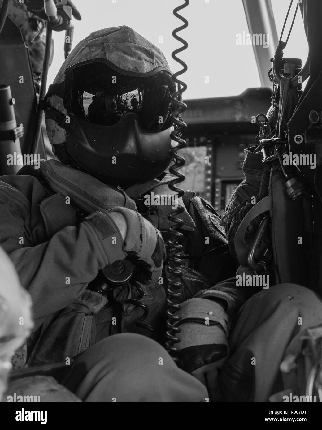 Un chef d'équipe avec l'escadron 262 à rotors basculants moyen maritime (renforcée) siège à bord d'un hélicoptère Huey UH-1Y pendant une simulation de haute altitude, ouverture faible saut en parachute et de la mission de reconnaissance et de surveillance dans le cadre de la 31e Marine Expeditionary Unit's MEU Exercice, Okinawa, Japon, le 8 décembre 2018. Marines avec la 31e MEU amphibie du peloton de reconnaissance se spécialisent dans de reconnaissance, de surveillance rapprochée et de tactique dans les opérations amphibies. La 31e MEU, le Marine Corps' seulement continuellement de l'avant-déployés MEU, fournit une force meurtrière et flexible prêt à exécuter un large rang Banque D'Images