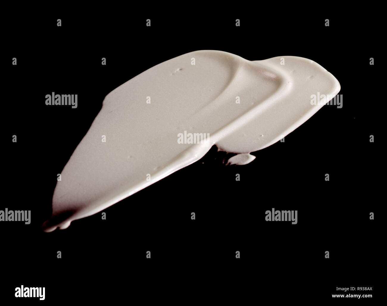 La texture d'une fondation liquide, fond noir Banque D'Images