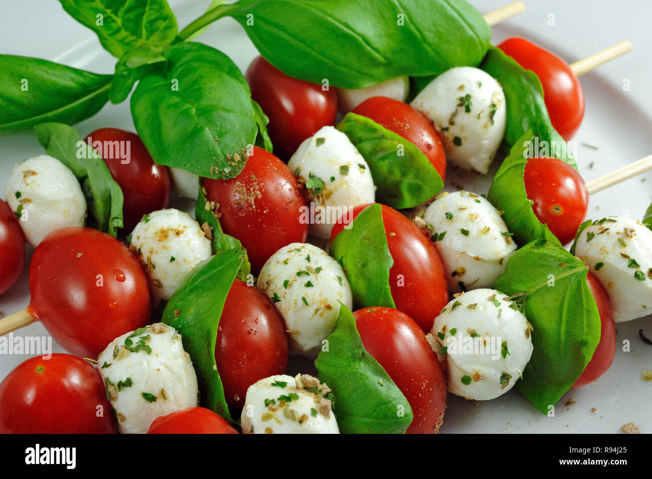 Quatre baguettes fraîches avec tomates cerises, mozzarella et basilic italien Banque D'Images