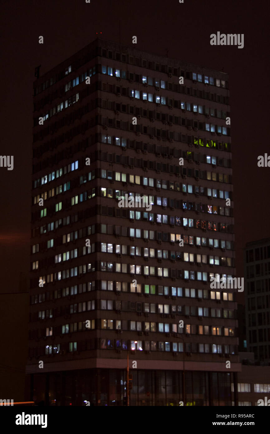 Immeuble de bureaux d'ossature avec des lumières de rue au centre-ville de réflexions sur une nuit d'hiver Banque D'Images