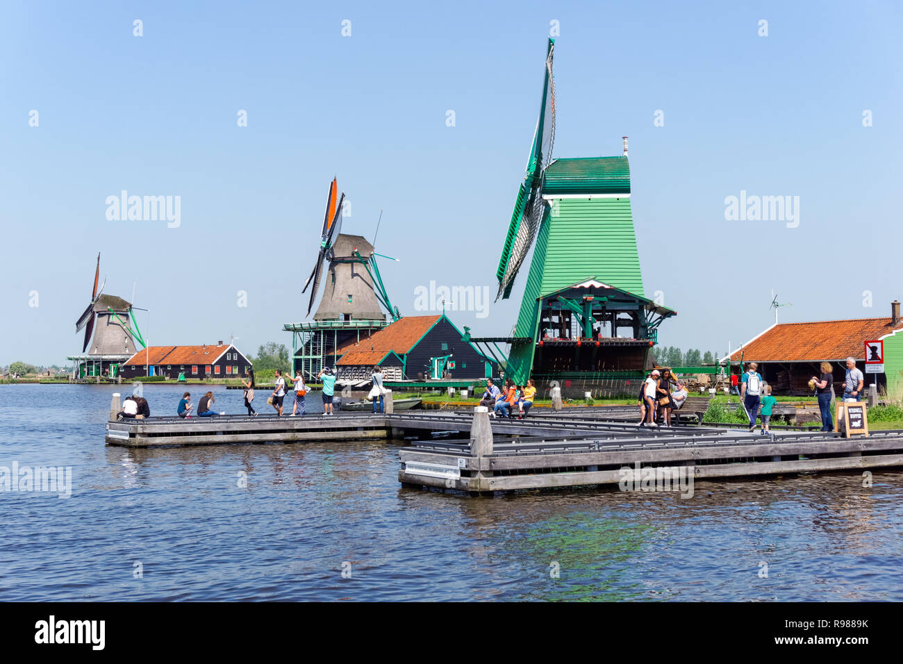 Les touristes à marcher le long des moulins à vent traditionnel néerlandais à Zaanse Schans en Pays-Bas Banque D'Images