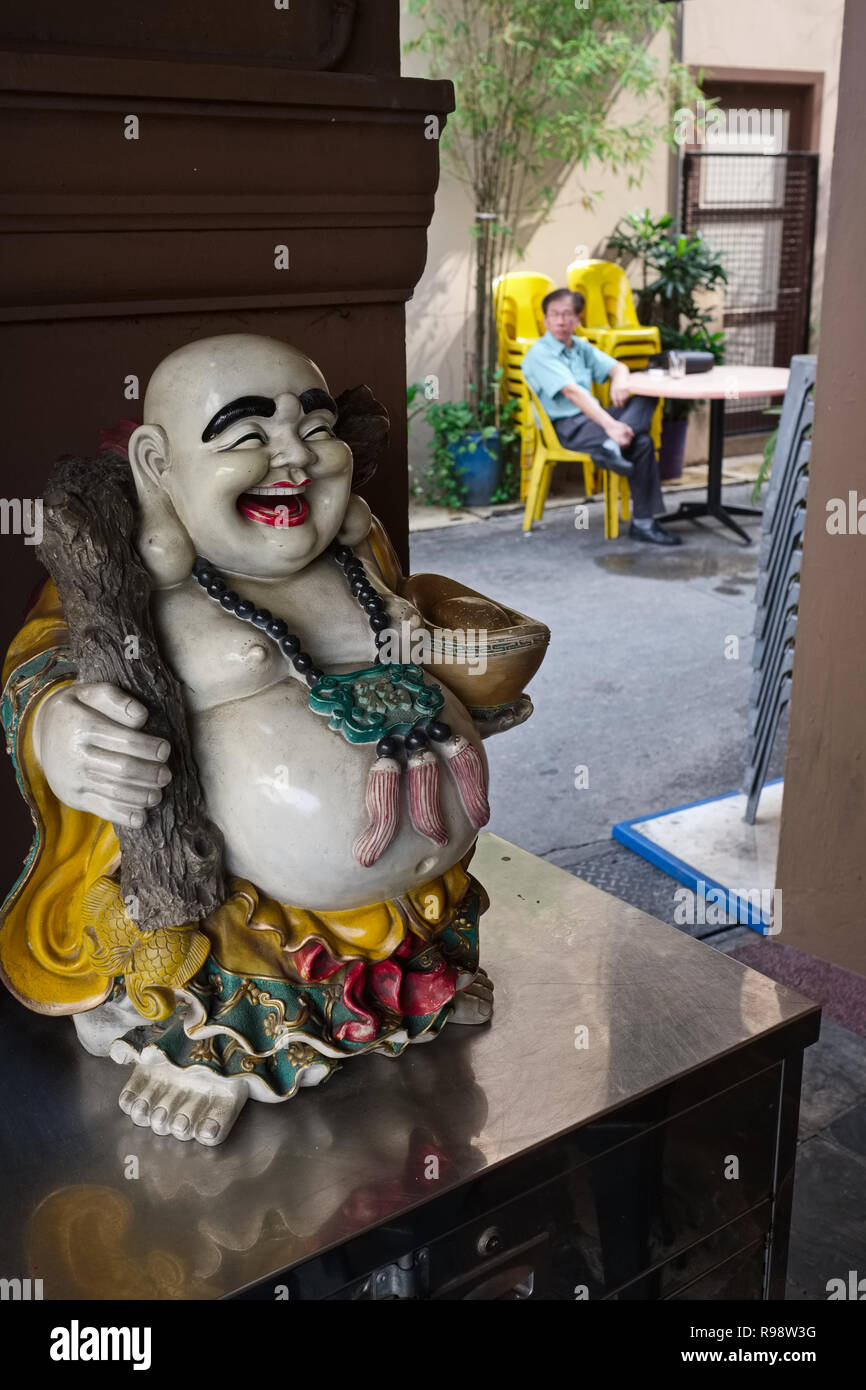 La figure d'un Hotei, souvent appelée Laughing Buddha, en fait un dieu japonais de contentement et de bonheur, dans un restaurant dans la zone de Geylang, Singapour Banque D'Images