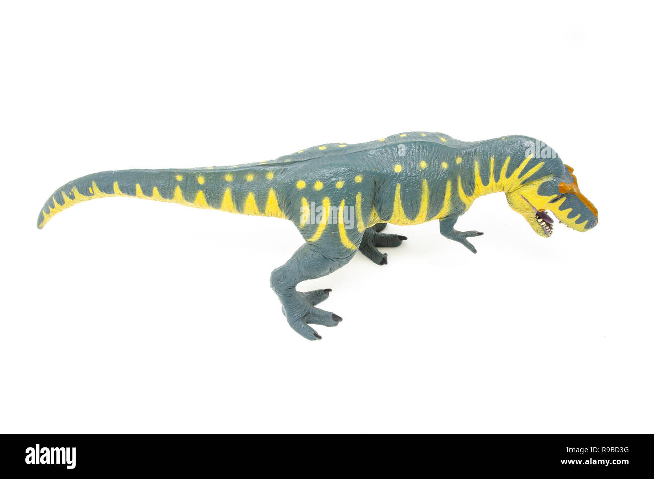 Vue de dessus de jaune bleu Battat Tyrannosaurus rex dinosaur toy, isolé sur un fond blanc. Banque D'Images