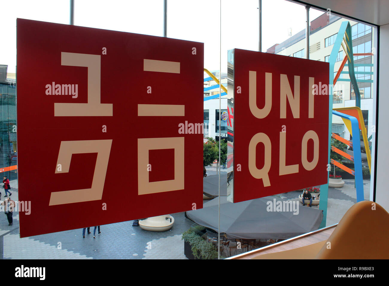 Vue de signer avec logo à l'intérieur vitrine de magasin de vêtements Uniqlo Banque D'Images