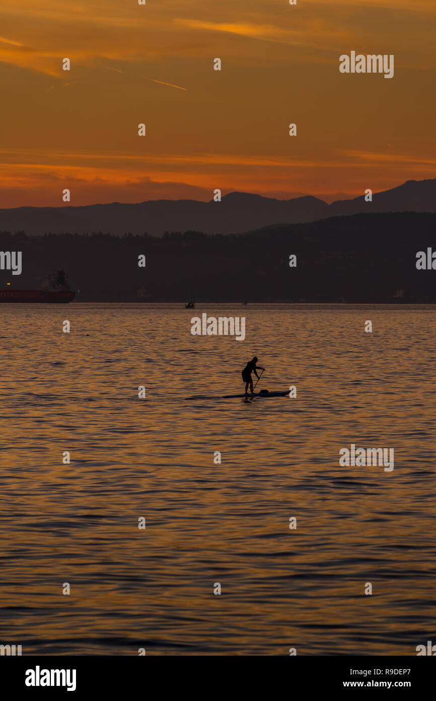 Femme en paddleboard à English Bay, Vancouner au coucher du soleil Banque D'Images