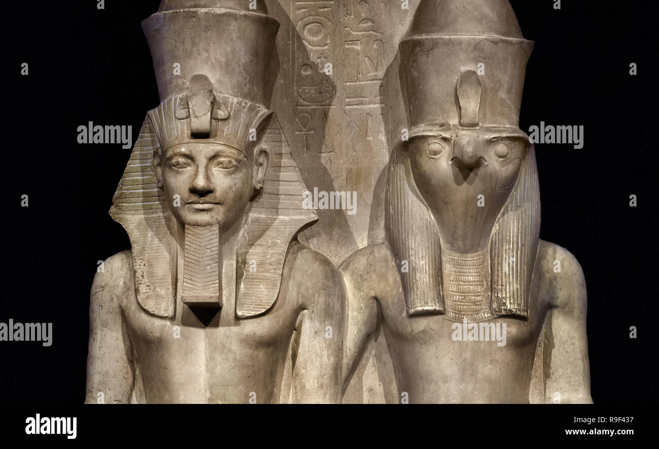 Droit d'Horus et d'Horemheb ce temple image représente le dieu Horus et le pharaon égyptien Horemheb (1319-1305 BC) assis côte à côte. Horus porte une tête de comme une puissance céleste. Le roi est de la même taille que le dieu, car selon les Égyptiens il est tout aussi puissant. Il est l'apparence terrestre d'Horus et ainsi lui-même un dieu. (1,52 mètres de calcaire : Nouvel Empire, xviiie dynastie (1319-1305 avant J.-C.) L'Égypte, l'Égyptien. Banque D'Images