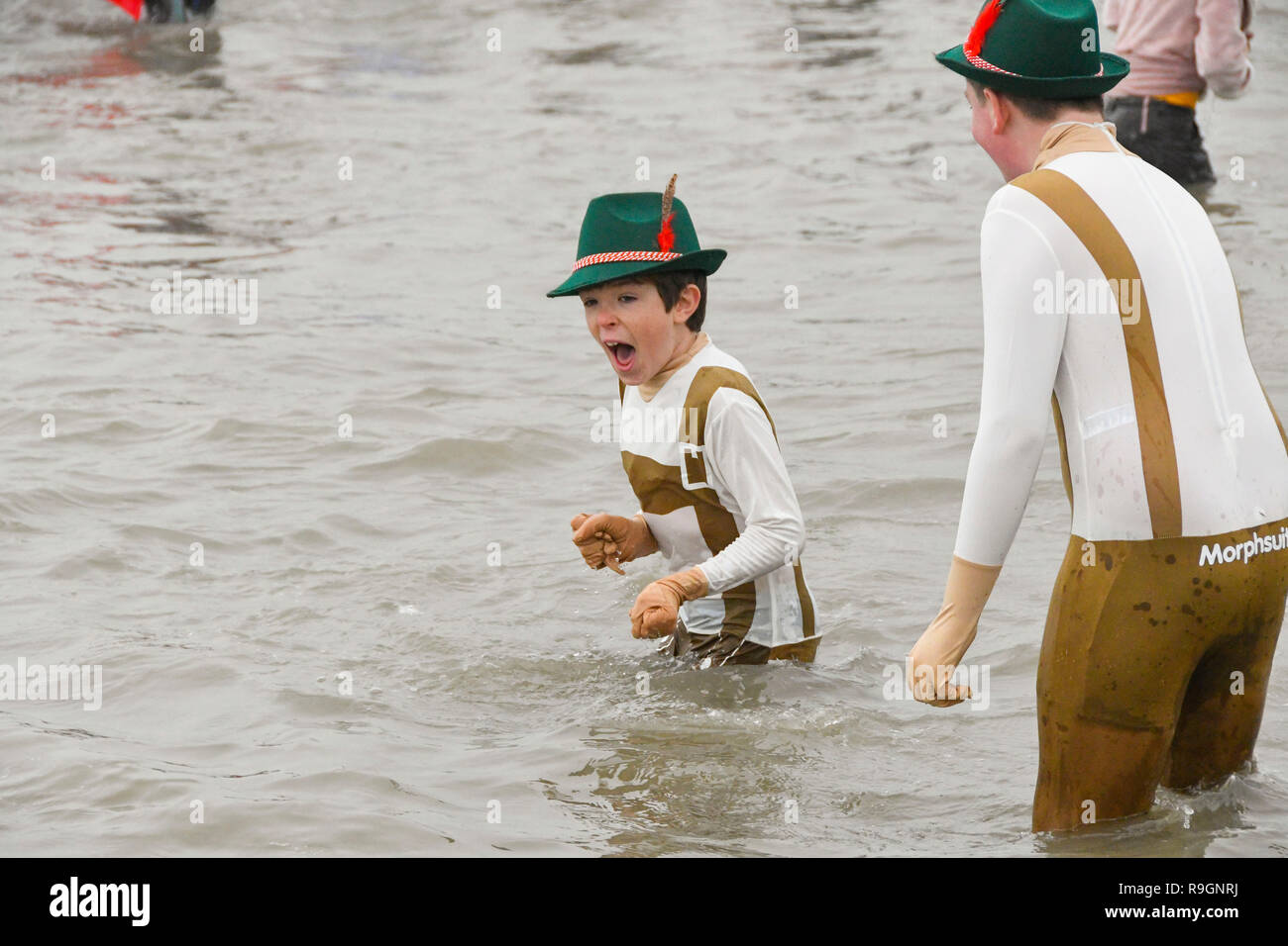 Charmouth, Dorset, UK. Dec 25, 2018. Le jour de Noël des nageurs portant robe de braver l'eau froide pour se rafraîchir dans la mer à Charmouth dans Dorset pour recueillir des fonds pour la RNLI. Crédit photo : Graham Hunt/Alamy Live News Banque D'Images