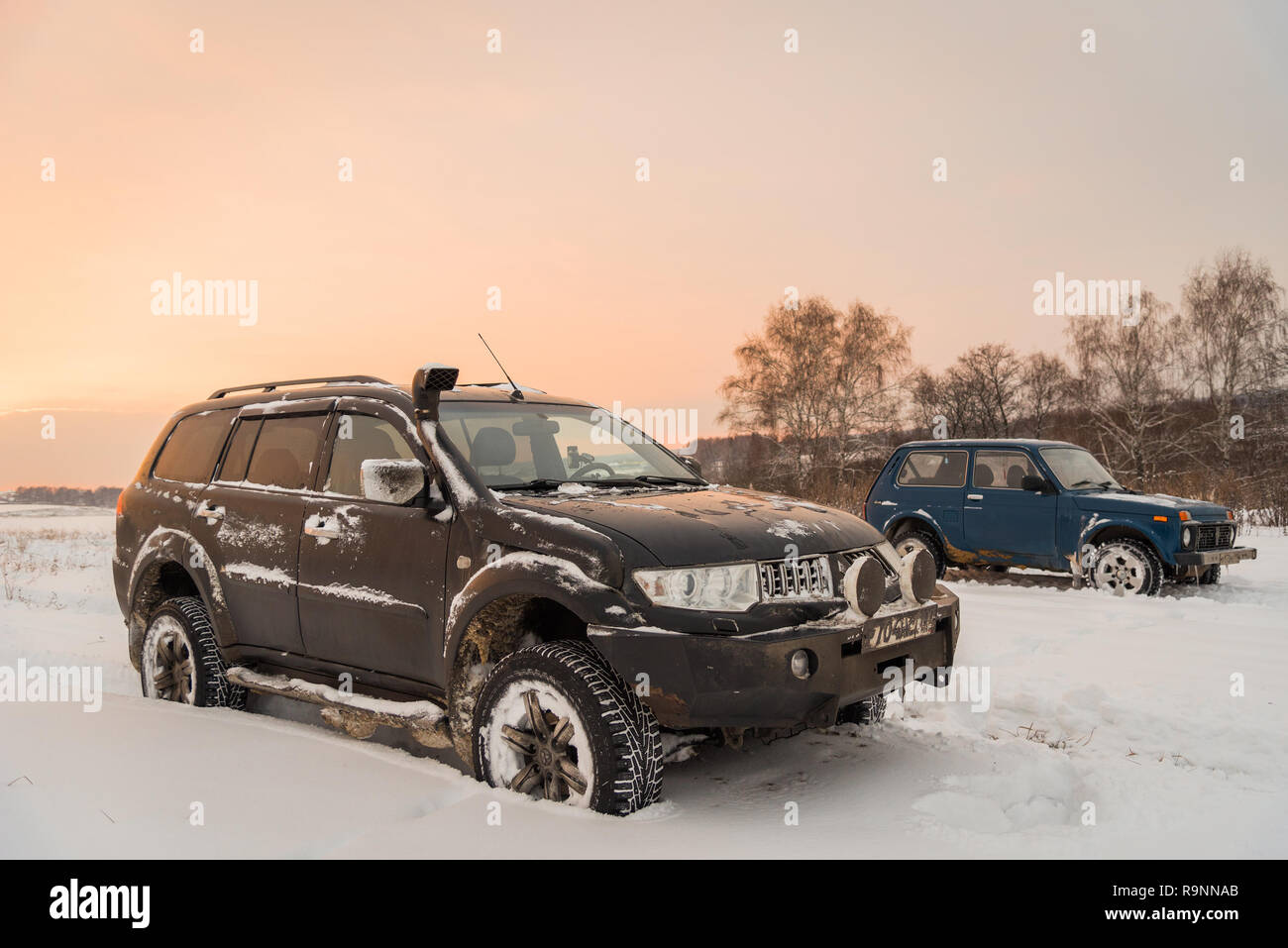 Moscou, Russie - le 25 décembre 2018 : Off-road cars Mitsubishi Pajero Sport (1100) et Lada Niva 4x4 (VAZ 2121 / 21214) stationné sur le champ de neige. Banque D'Images