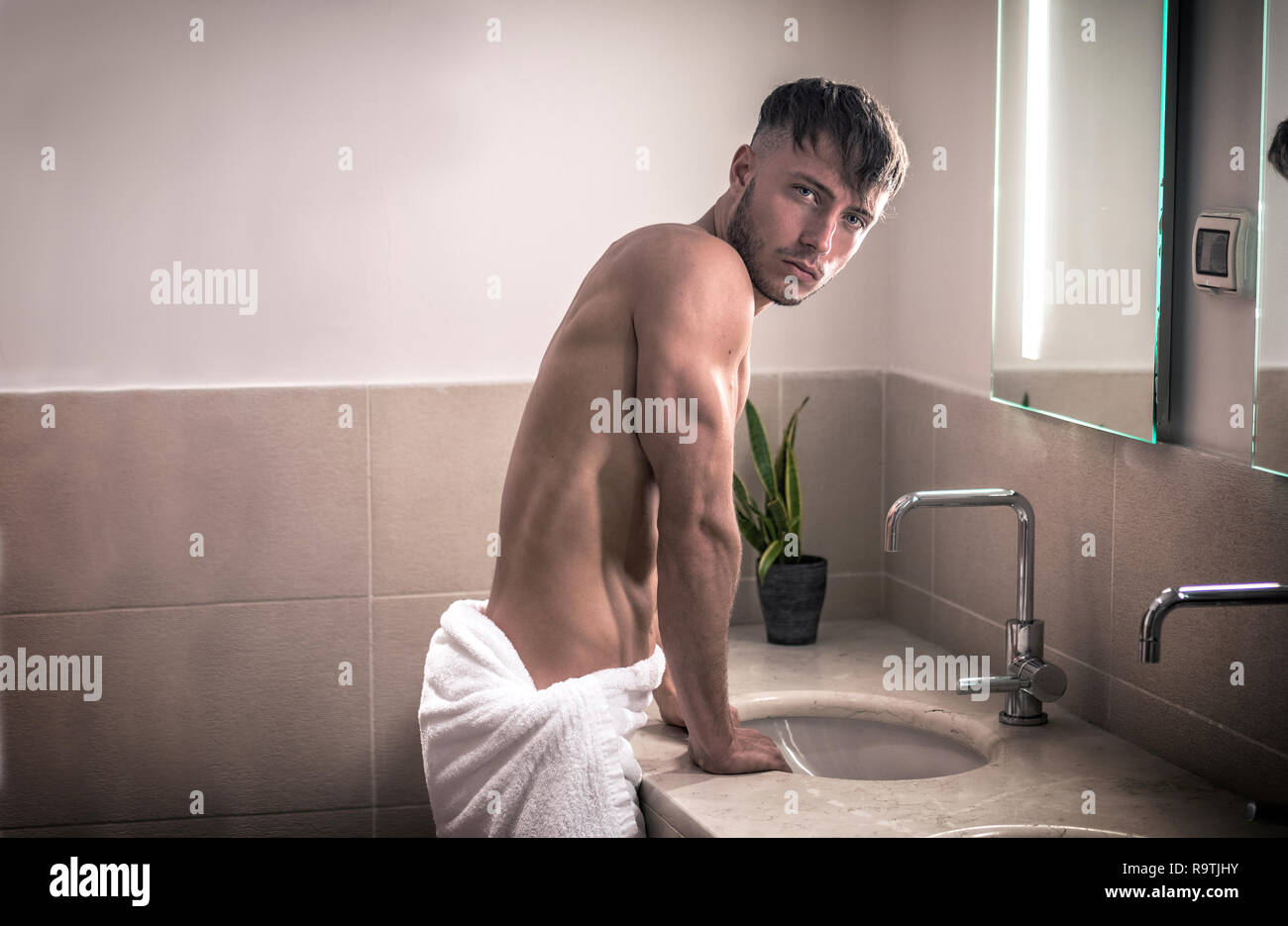 Nu Dans La Salle De Bain Jeune homme torse nu dans la salle de bains looking at camera Photo Stock - Alamy