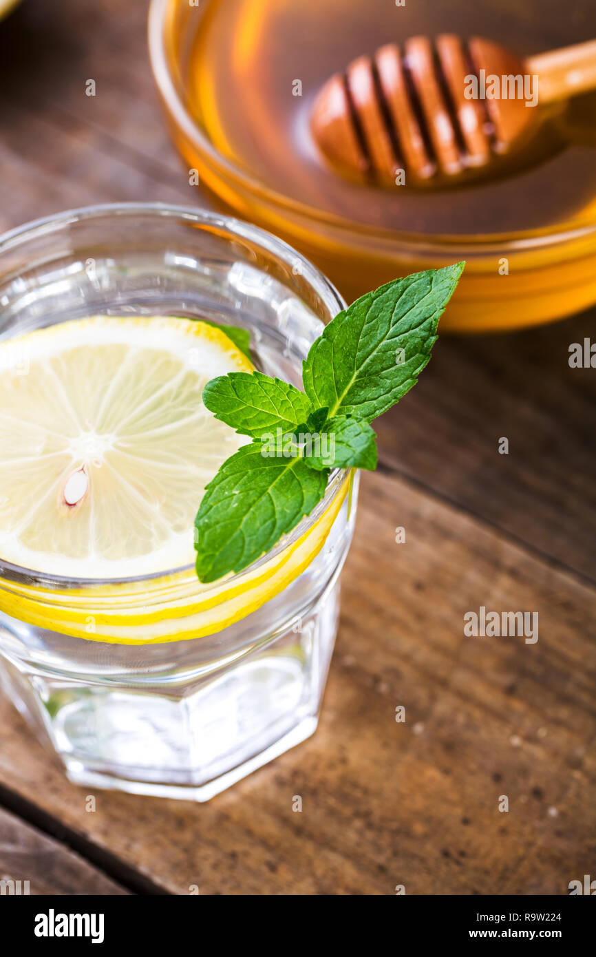 Le miel et le jus de citron. L'eau de désintoxication avec du miel, du citron et de la menthe, de la santé et de l'organique. Banque D'Images