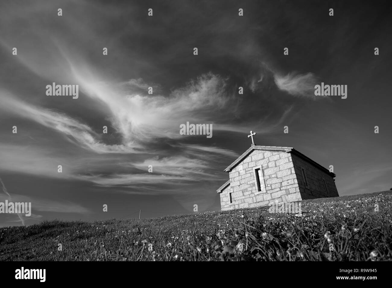 Ancienne chapelle de granit au sommet d'une colline au coucher du soleil. Banque D'Images