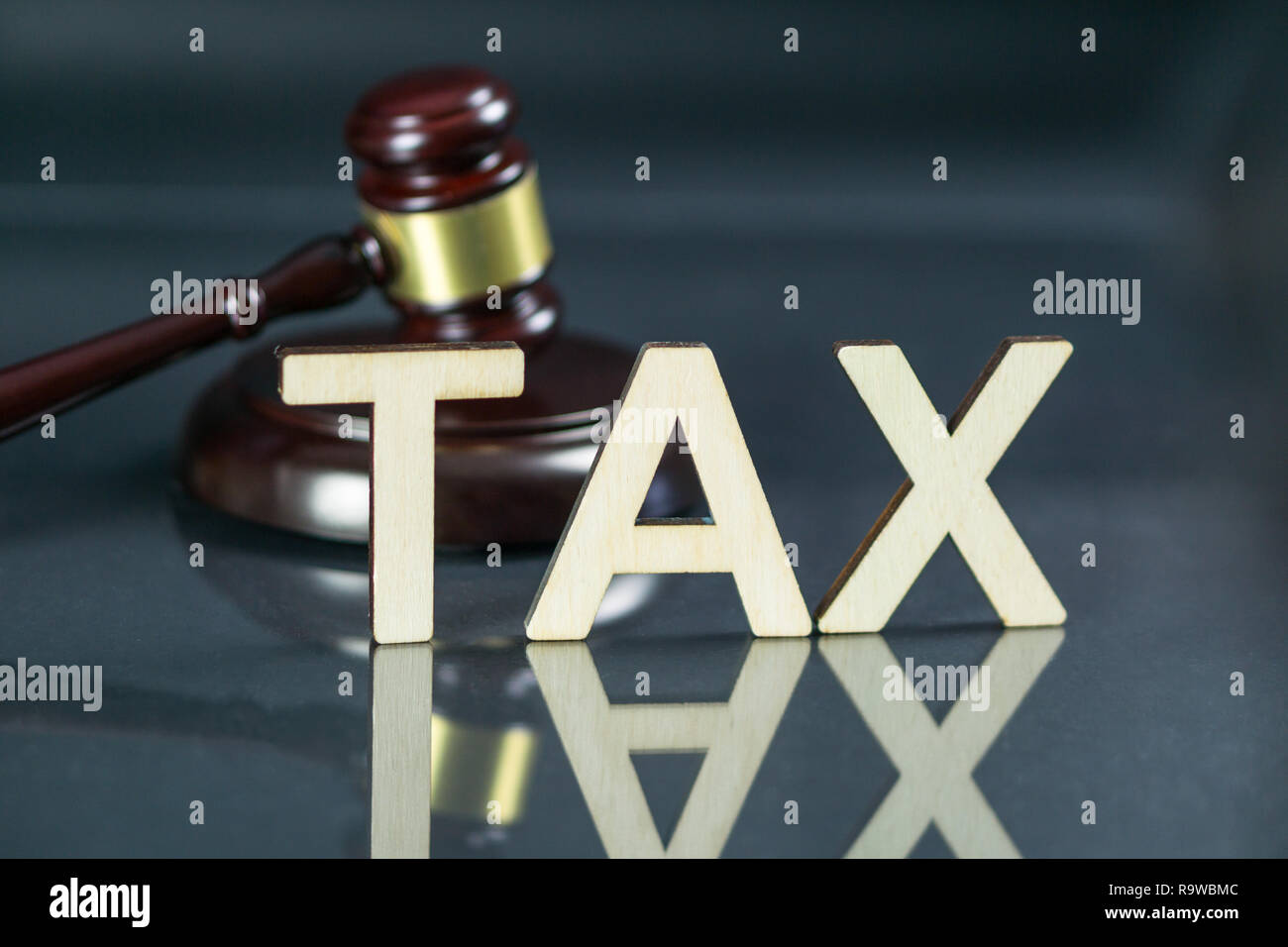 Concept du droit fiscal. Mot taxe avec marteau et de l'argent sur la table. Banque D'Images