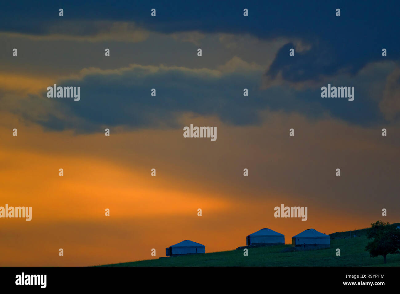 Camp de yourte mongole à la campagne de steppe sur orange ciel du soir, Khan Khentii zone strictement protégée, la Mongolie Banque D'Images