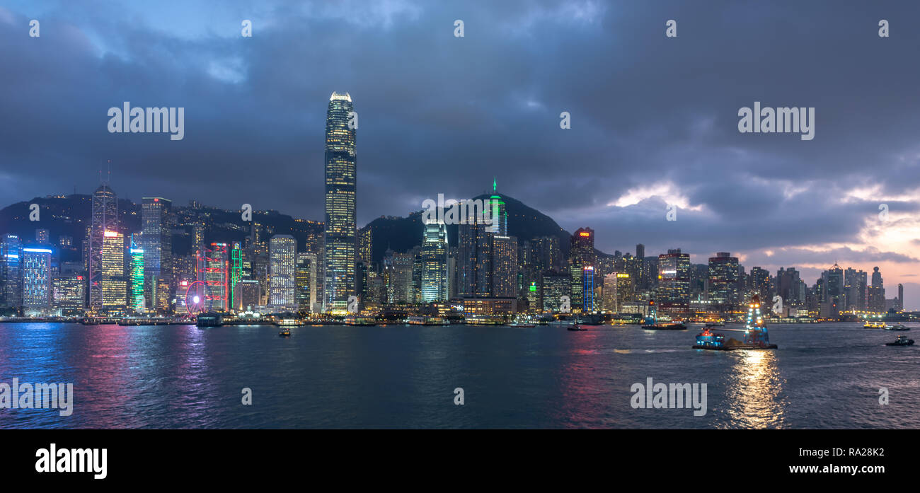 Hong Kong skyline scintillant du port de Victoria s'allume alors que le soleil se couche sur Sai Ying Pun Banque D'Images