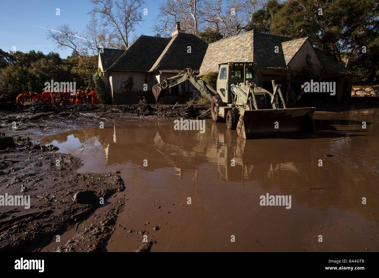Les soldats de la 315e compagnie de construction verticale, la Garde nationale de Californie, enlever les débris, le 13 janvier 2018, dans un quartier, la Californie, Montecito. L'unité creusé dehors maisons et de routes à la suite d'un éboulement dévastateur le 9 janvier qui a tué au moins 20 personnes, détruit des maisons et quartiers gauche coupé. (U.S. Photo de la Garde nationale aérienne Aviateur Senior Housman Crystal) Banque D'Images