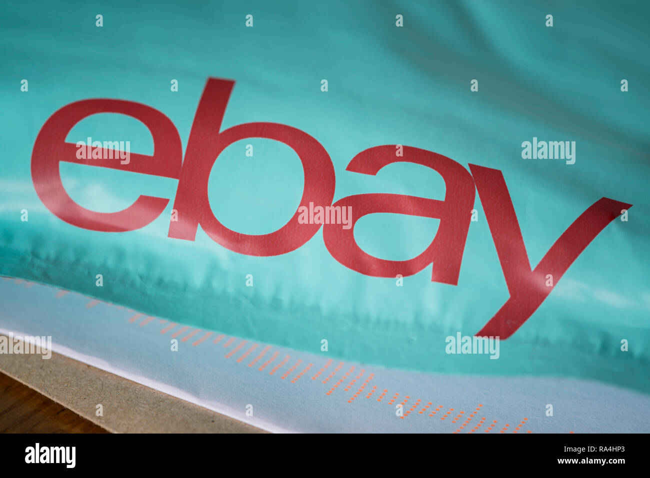 Un forfait de livraison Ebay en appui sur le sol avec des lettres reçues par la poste. Banque D'Images