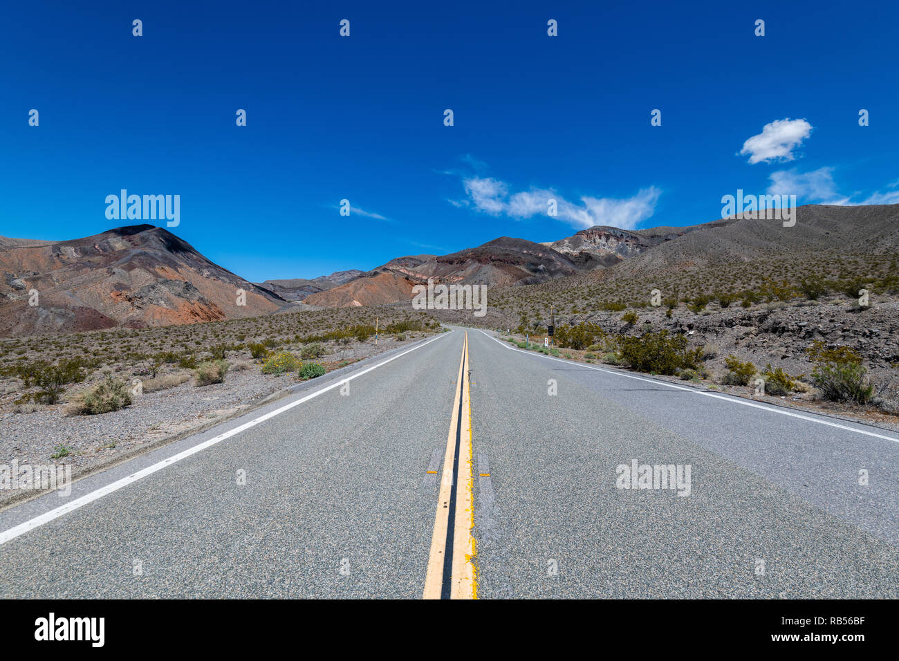 Paysage avec un long désert route droite dans la Death Valley National Park, California, USA. Banque D'Images